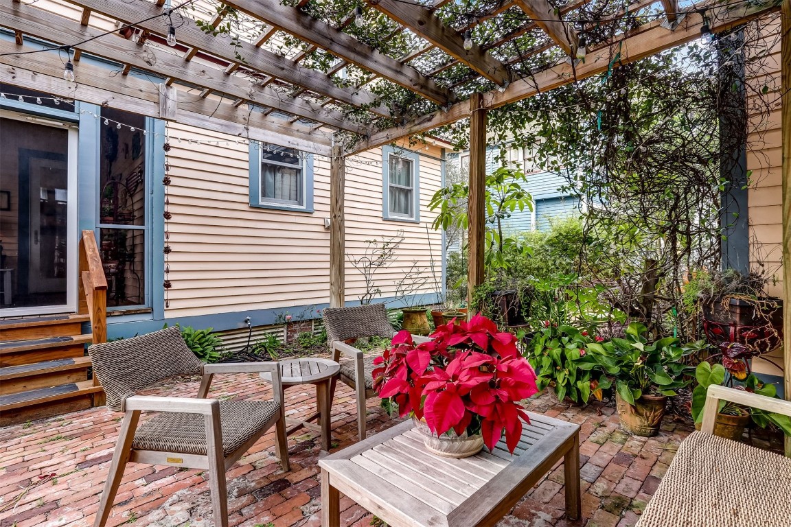 22 North 4th Street Fernandina Beach, FL 32034 - Photo 61 of 100 a view of a patio with a table and chairs and potted plants