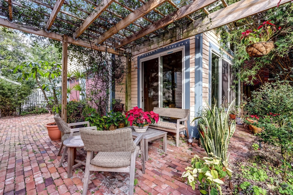 22 North 4th Street Fernandina Beach, FL 32034 - Photo 63 of 100 a view of a patio with table and chairs potted plants and floor to ceiling window