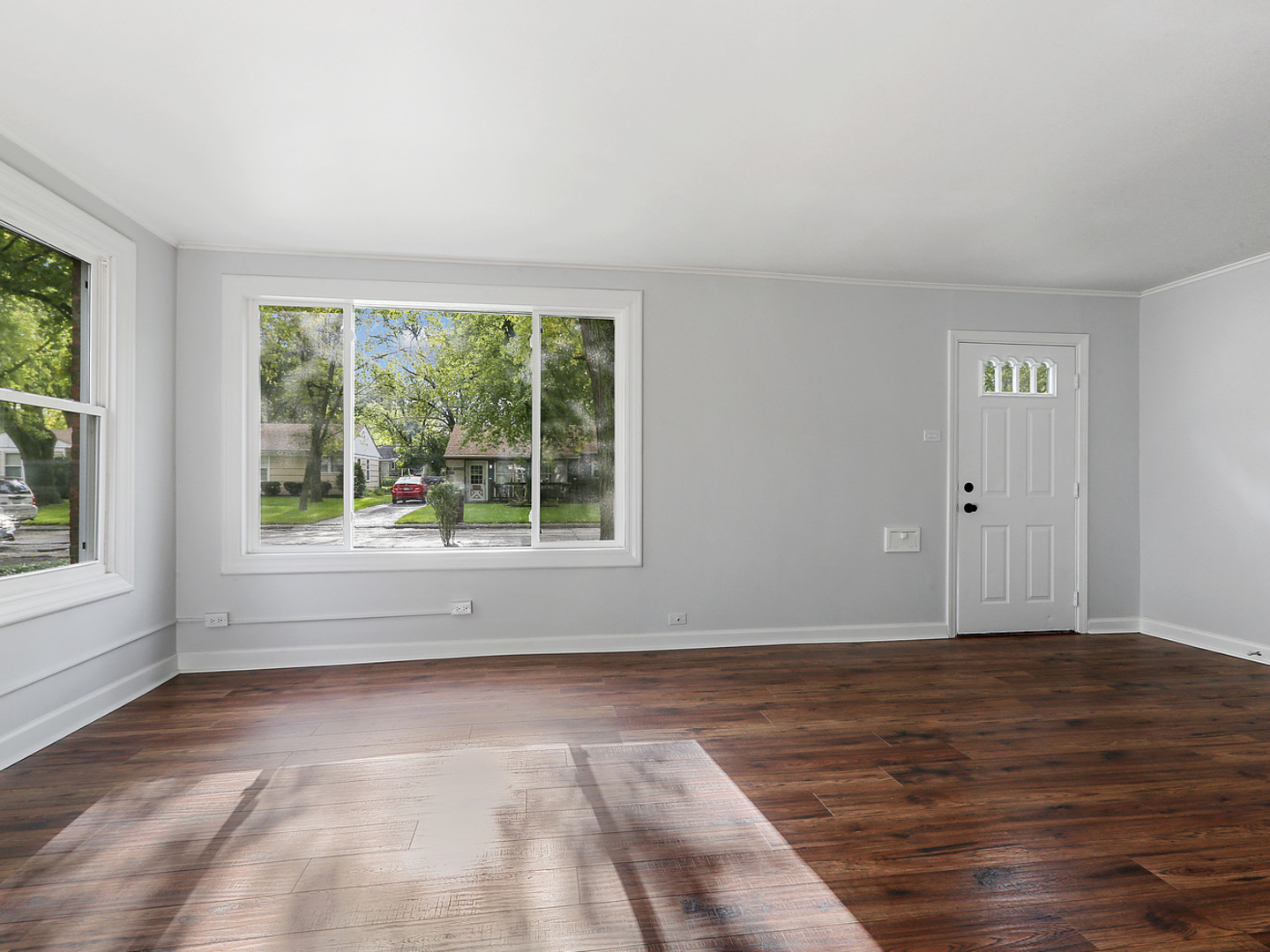 336 Manitowac Street Park Forest, IL 60466 - Photo 4 of 13 a view of an empty room with wooden floor and a window
