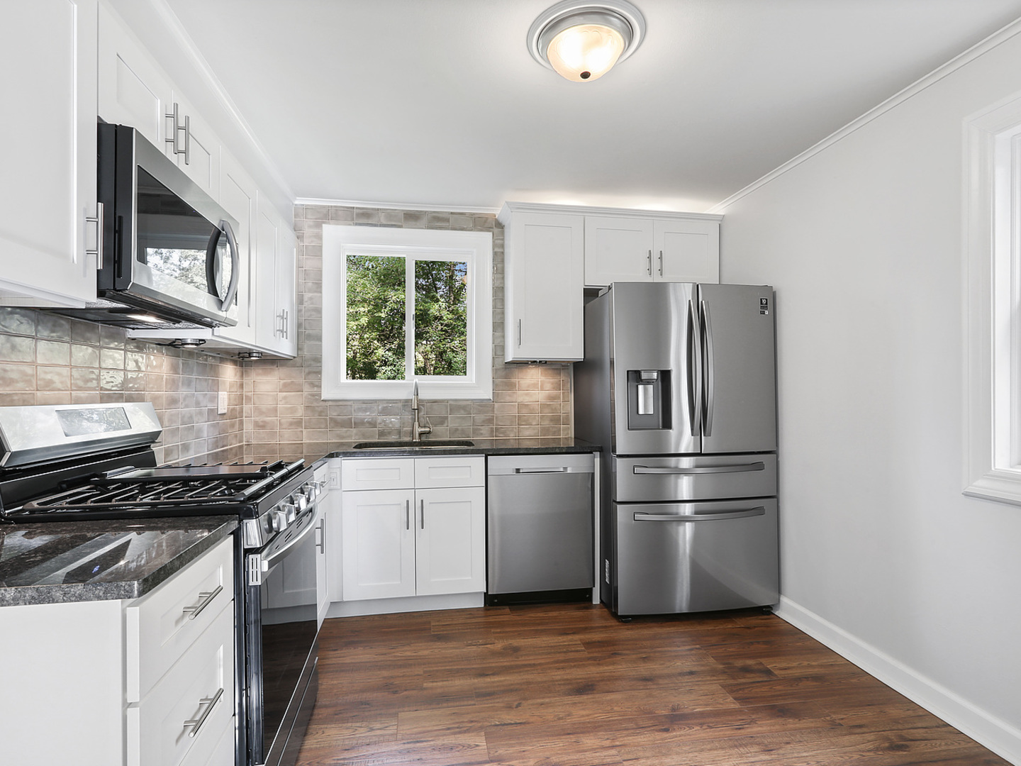 336 Manitowac Street Park Forest, IL 60466 - Photo 5 of 13 a kitchen with a refrigerator stove and microwave