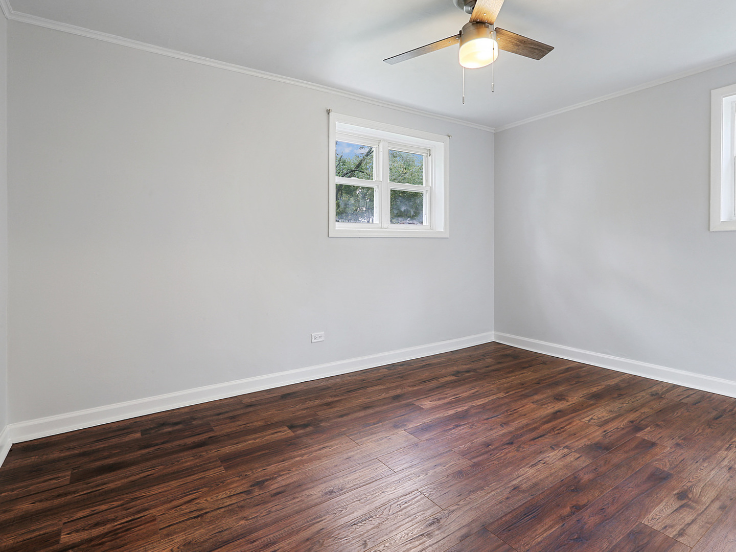 336 Manitowac Street Park Forest, IL 60466 - Photo 7 of 13 a view of an empty room with wooden floor and a window