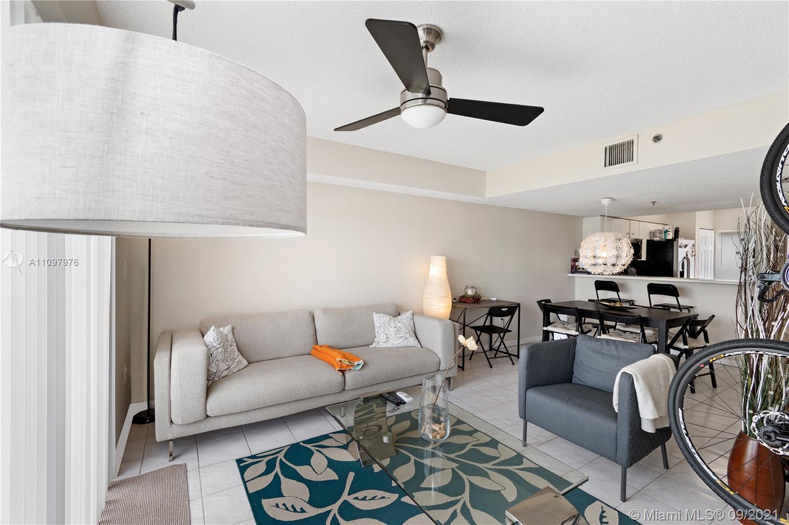 184 Riviera Circle, Unit 325 Weston, FL 33326 - Photo 2 of 27 a living room with furniture and wooden floor