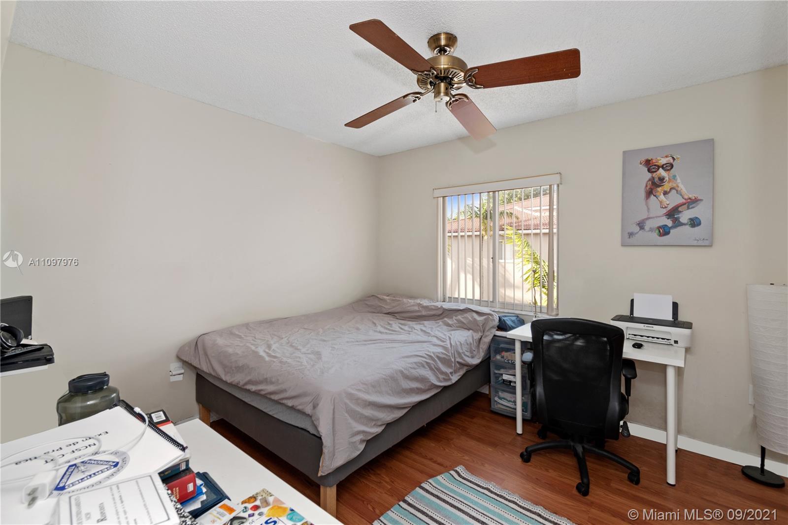 184 Riviera Circle, Unit 325 Weston, FL 33326 - Photo 14 of 27 a bedroom that has a bed and a chair in it