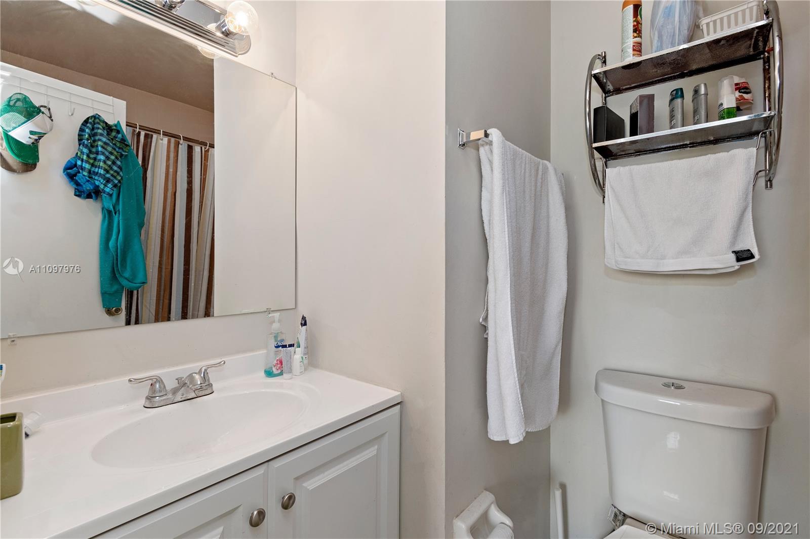 184 Riviera Circle, Unit 325 Weston, FL 33326 - Photo 16 of 27 a bathroom with a sink a toilet and a mirror