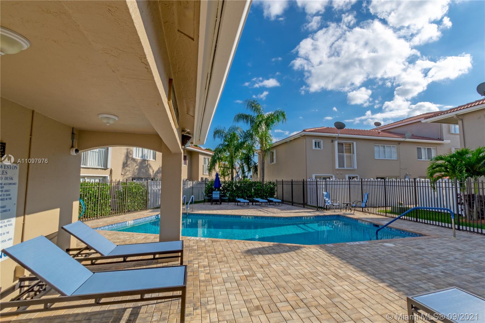 184 Riviera Circle, Unit 325 Weston, FL 33326 - Photo 26 of 27 a view of a house with backyard porch and sitting area