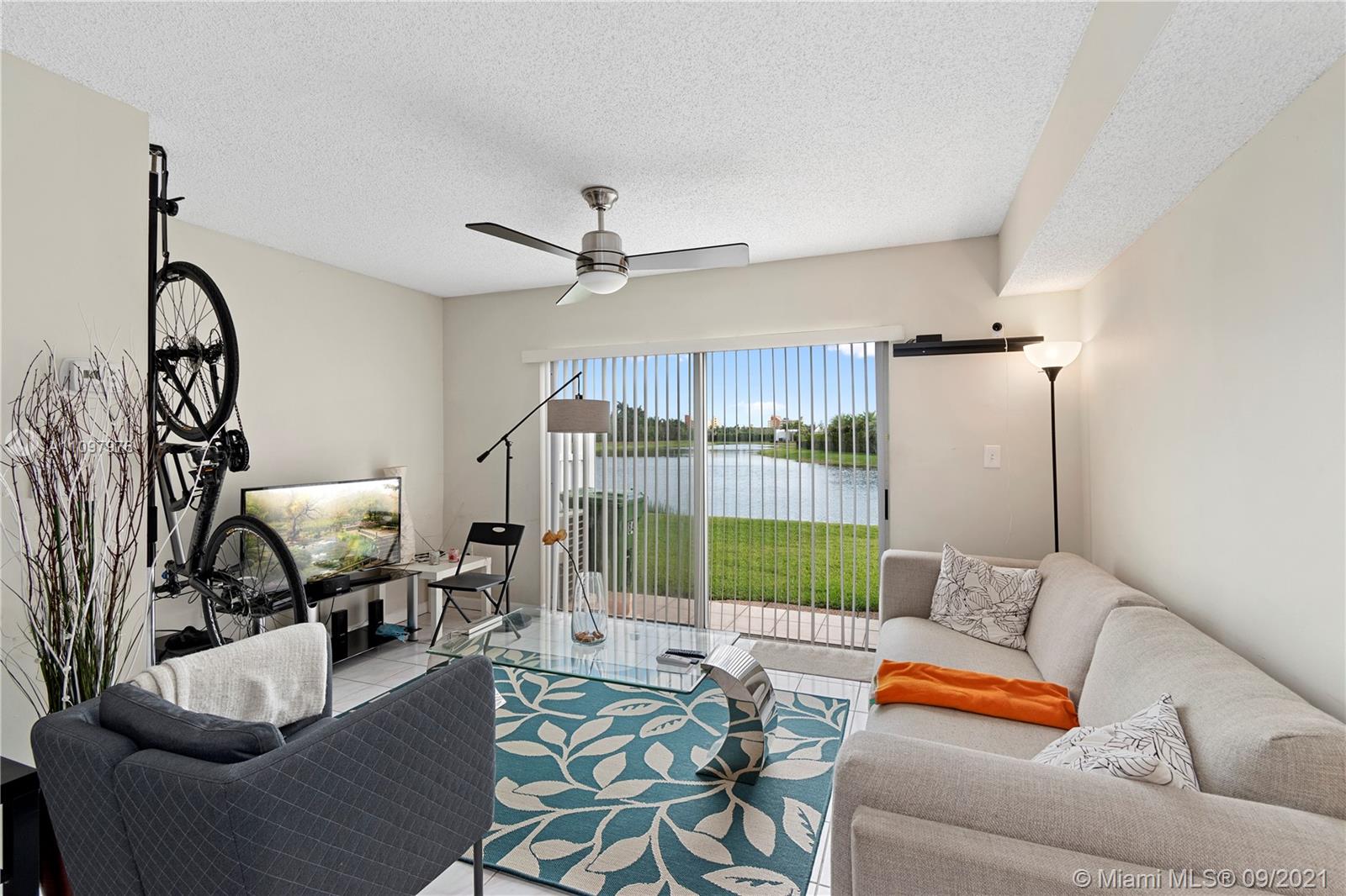 184 Riviera Circle, Unit 325 Weston, FL 33326 - Photo 5 of 27 a living room with furniture and a floor to ceiling window