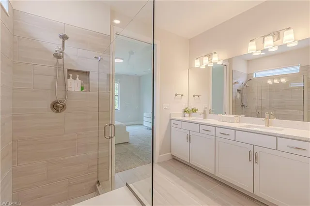 a bathroom with a double vanity sink mirror and shower