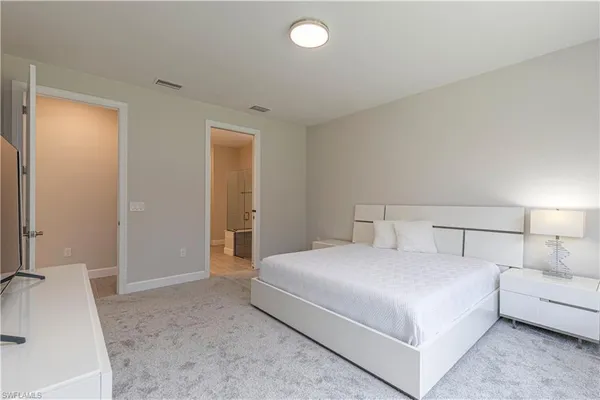a bedroom with a bed and a couch