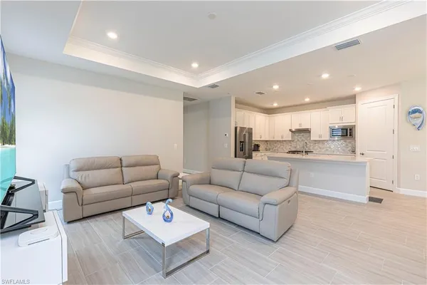 a living room with furniture white walls and white walls