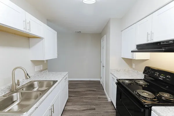 a kitchen with sink a stove and refrigerator