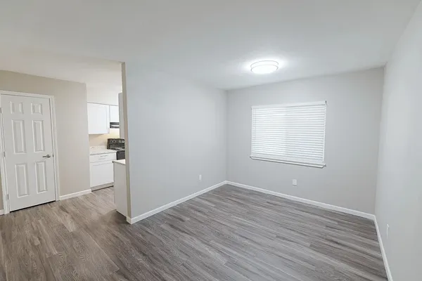 wooden floor in an empty room with a window