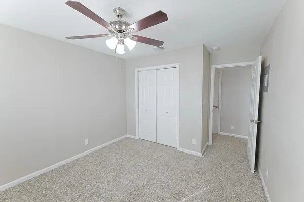 a view of an empty room with a fan