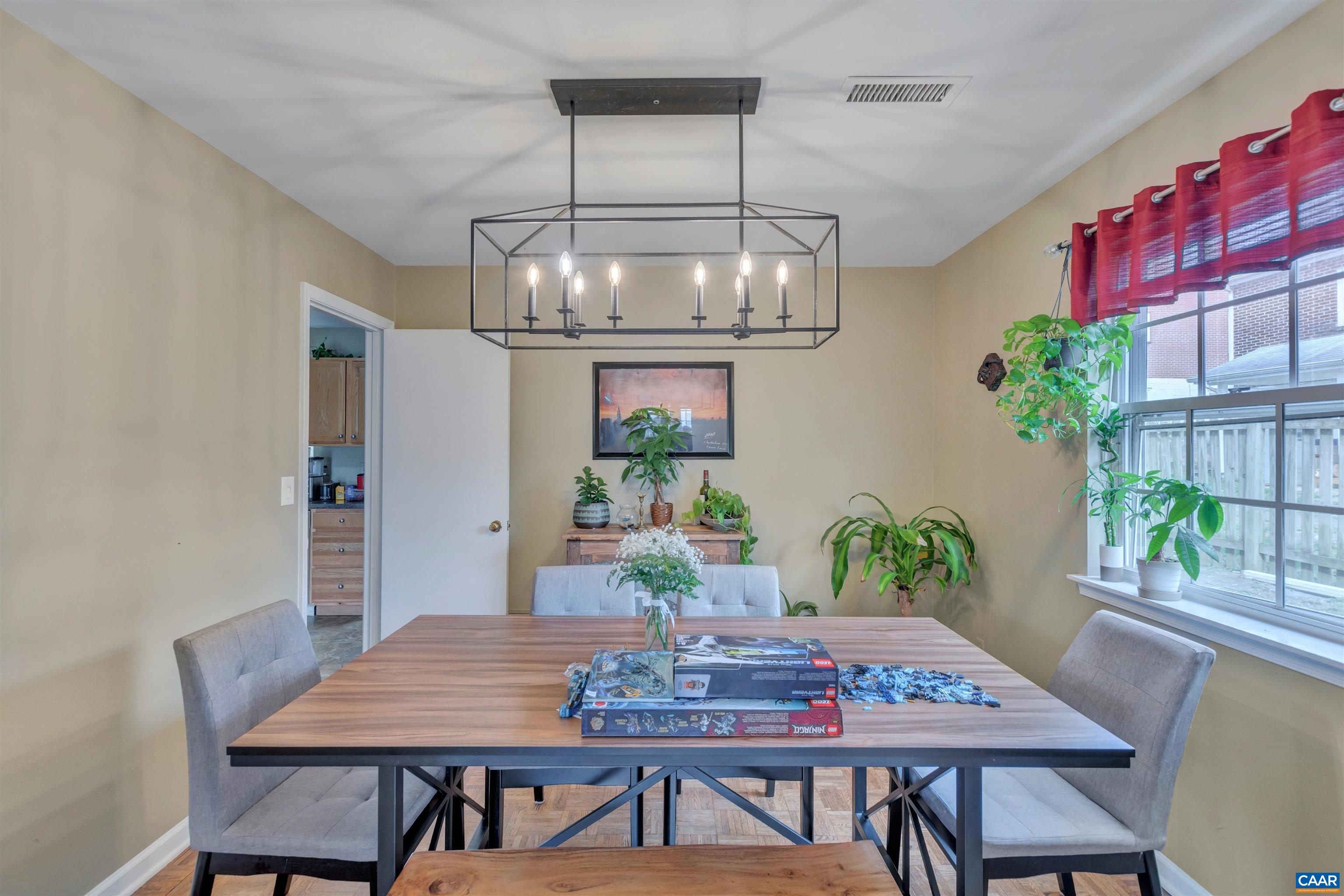 113 Summit Street, Unit 113 Charlottesville, VA 22903 - Photo 2 of 15 a view of a dining room with furniture a chandelier and wooden floor
