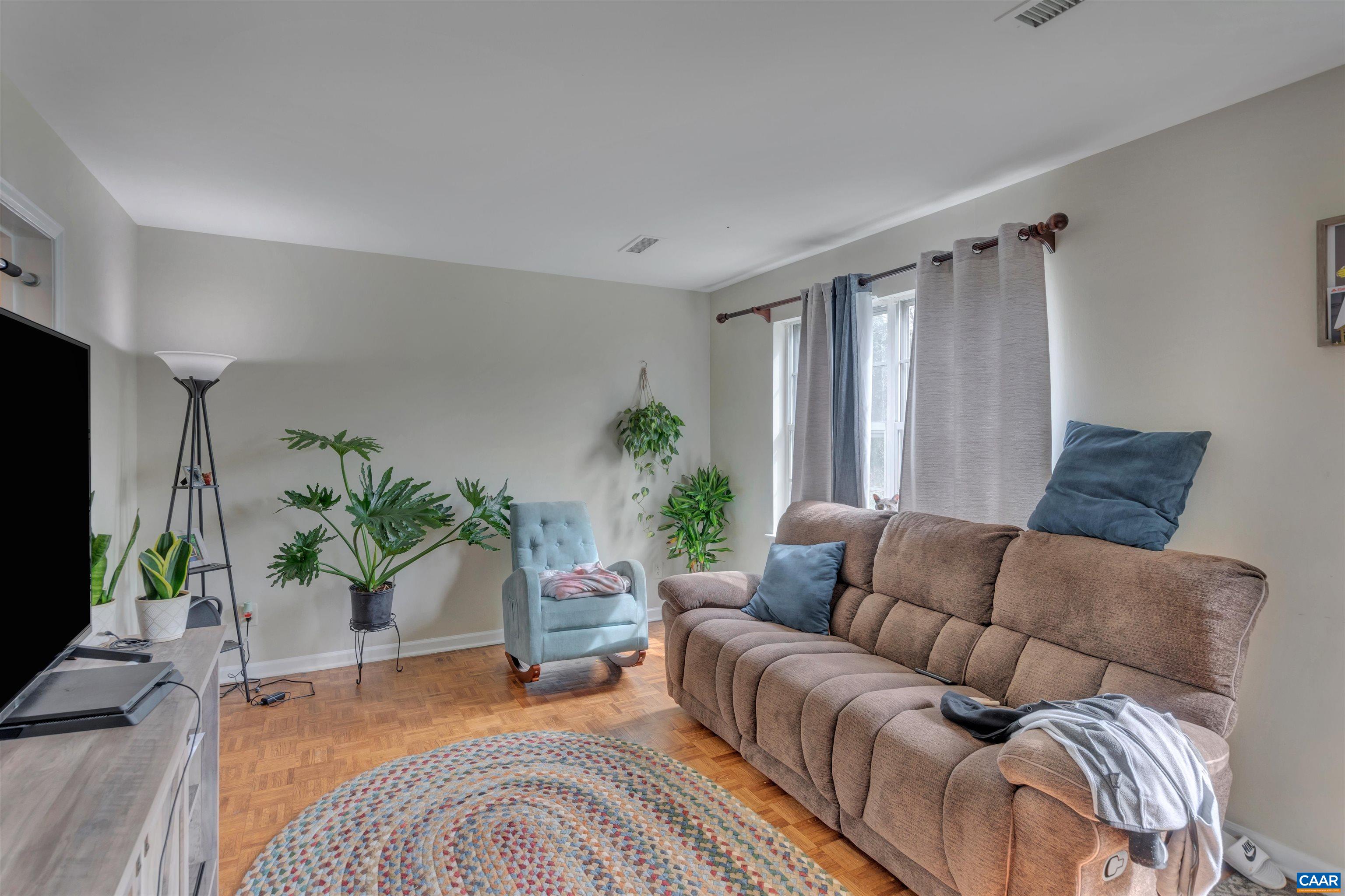 113 Summit Street, Unit 113 Charlottesville, VA 22903 - Photo 3 of 15 a living room with furniture and a large window
