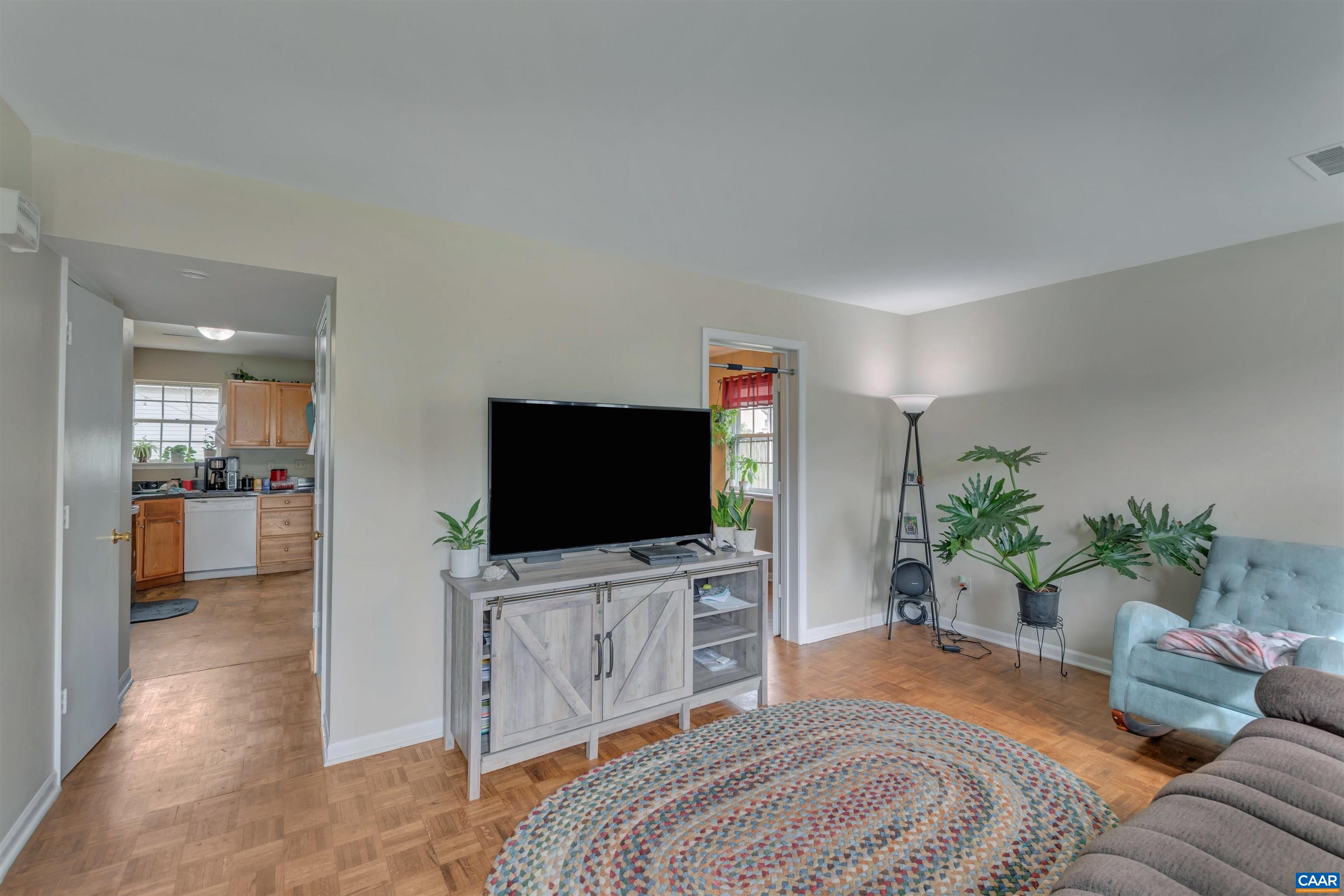 113 Summit Street, Unit 113 Charlottesville, VA 22903 - Photo 5 of 15 a bedroom with furniture and a flat screen tv