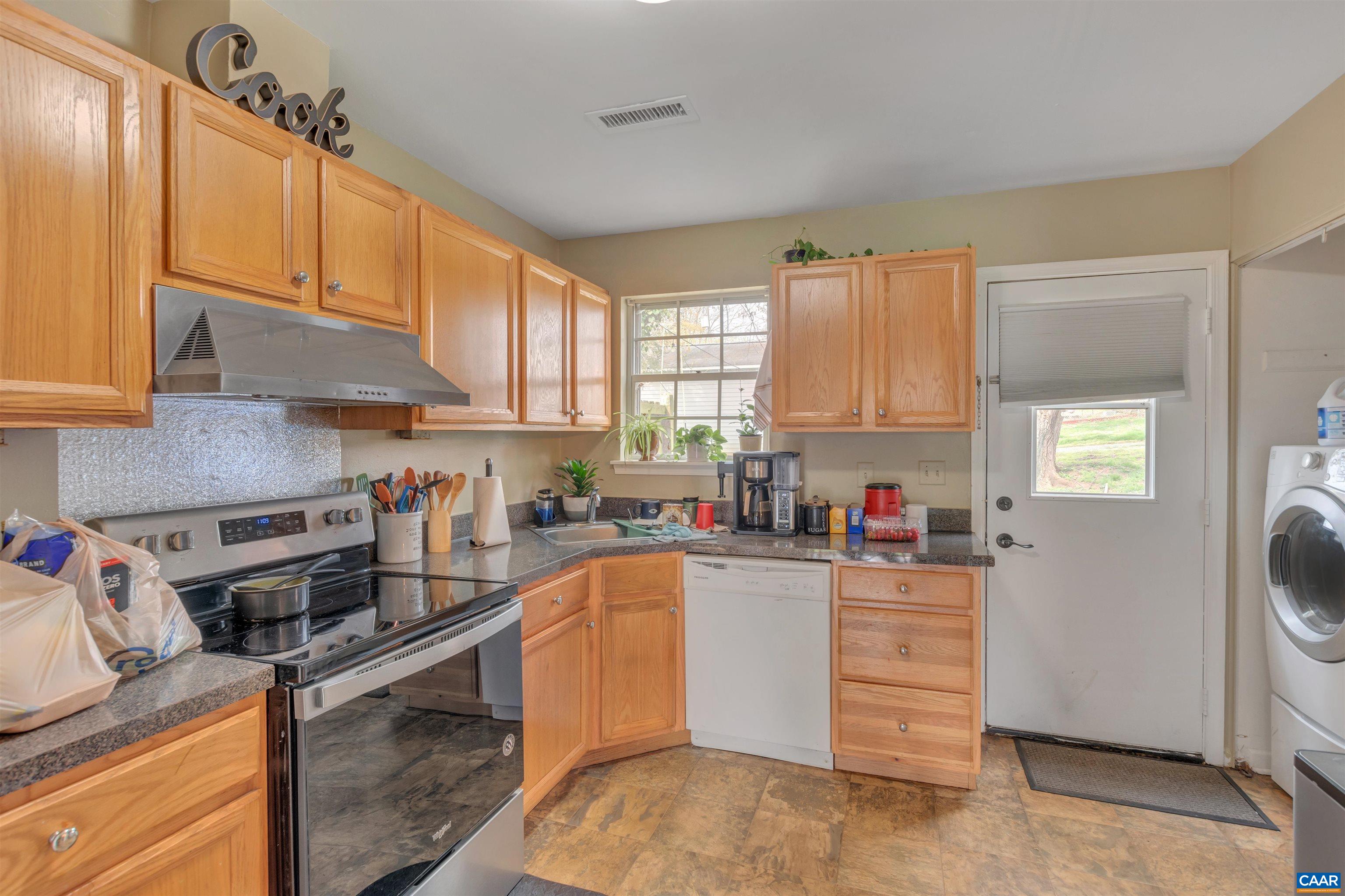 113 Summit Street, Unit 113 Charlottesville, VA 22903 - Photo 6 of 15 a kitchen with stainless steel appliances granite countertop a stove refrigerator sink and cabinets