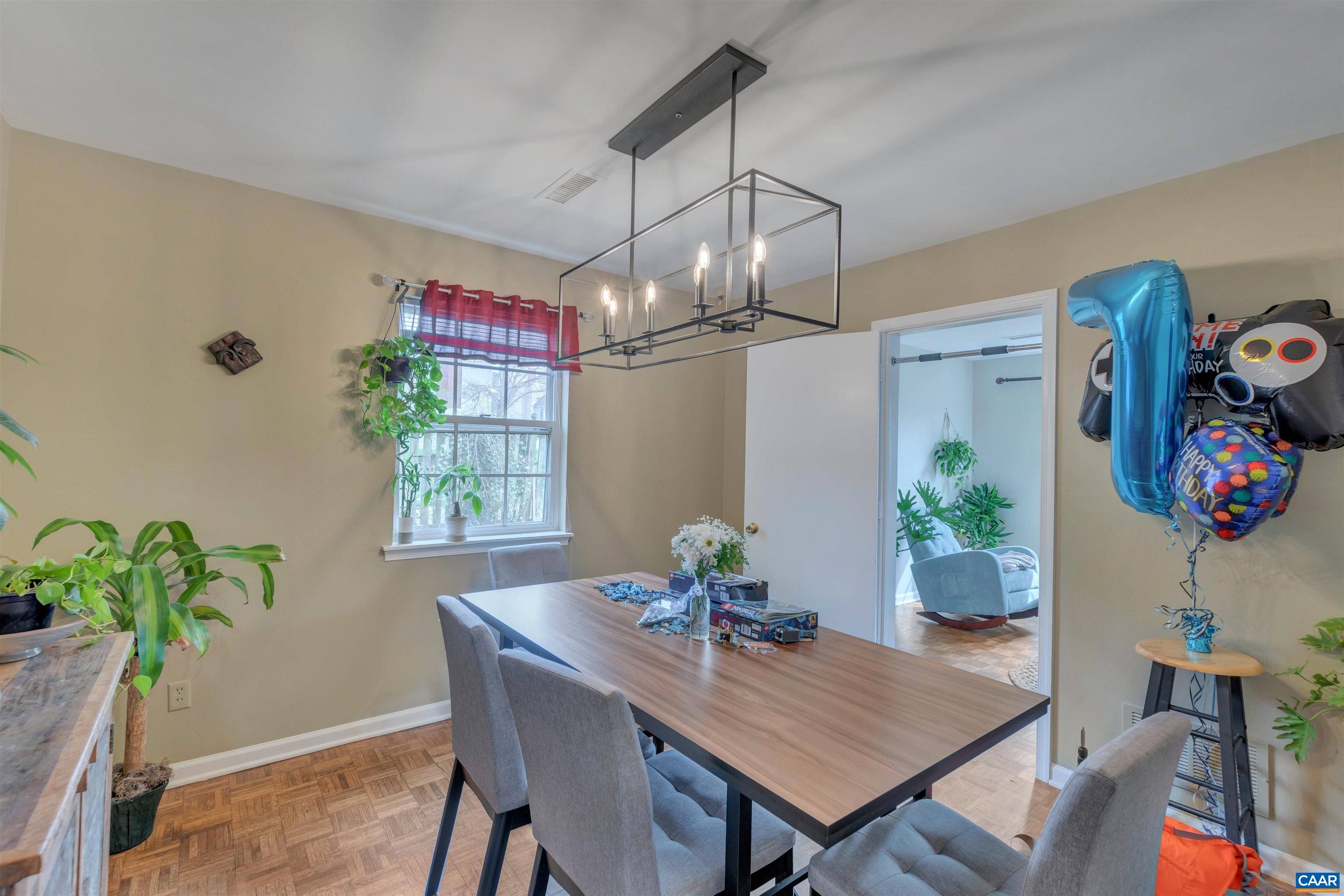 113 Summit Street, Unit 113 Charlottesville, VA 22903 - Photo 9 of 15 a view of a dining room with furniture window and wooden floor