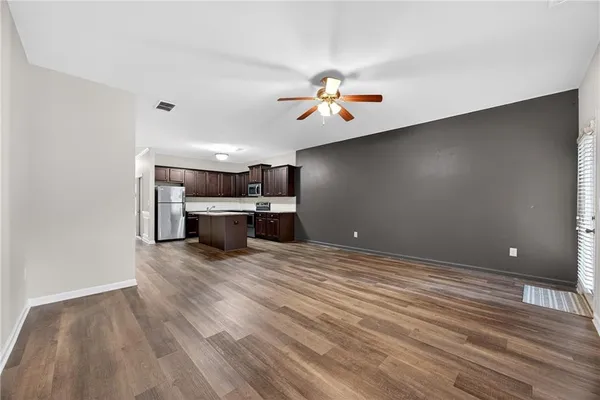 a view of a livingroom with a furniture wooden floor and window