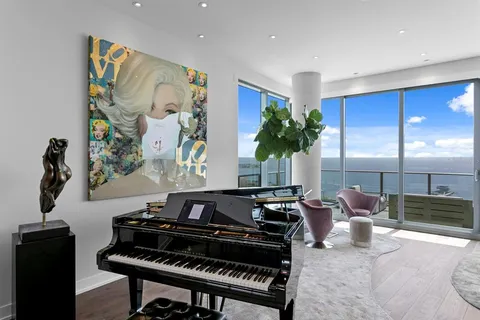 a kitchen with a refrigerator and white cabinets