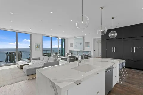 a bedroom with a bed a flat screen tv and a window