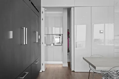 a very nice looking dining room with a large window and chandelier