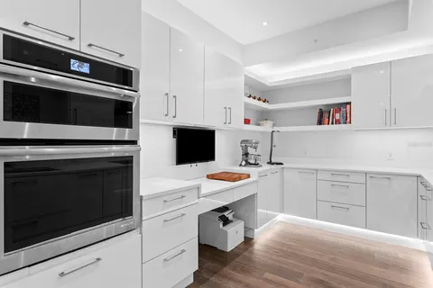 a view of a room with a chandelier and living room view
