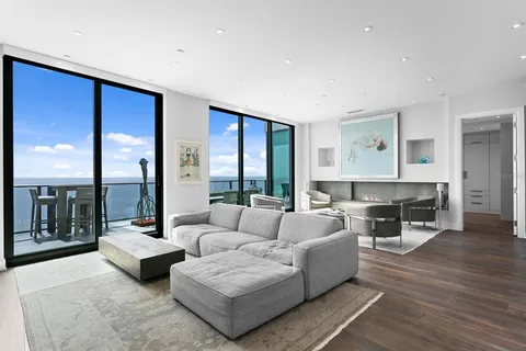 a bedroom with a bed a dresser and flat screen tv