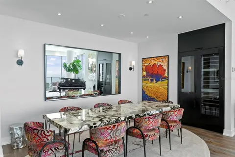 a living room with furniture a rug and white walls