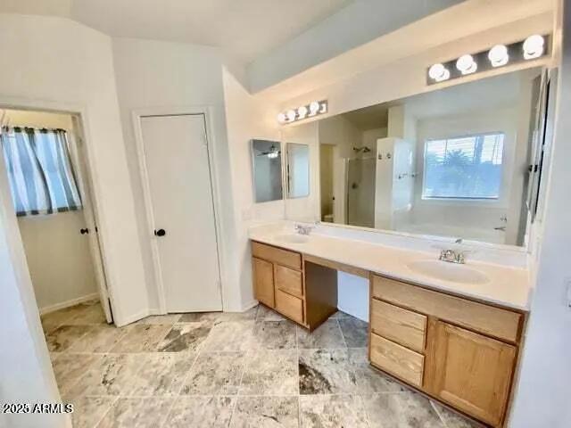 a spacious bathroom with a sink and a mirror
