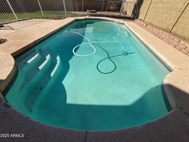a view of a swimming pool with a outdoor seating