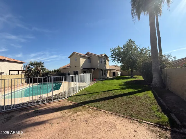 a view of a house with a yard next to a road
