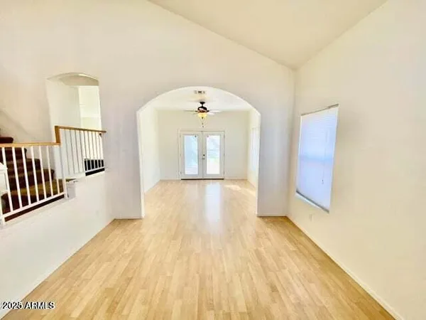a view of a room with wooden floor and window
