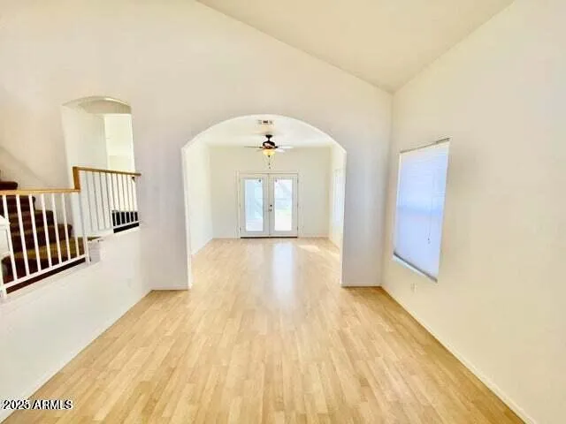 a view of a room with wooden floor and window