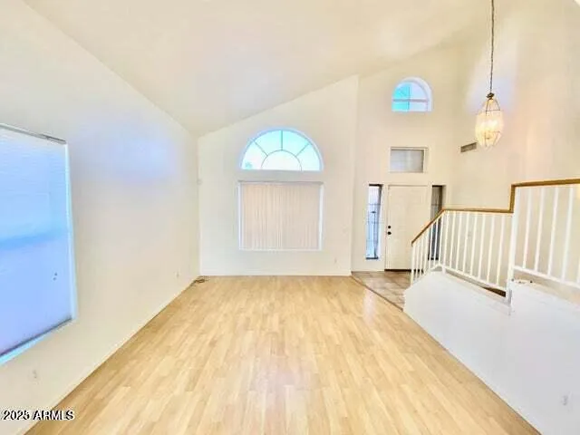 a view of a room with wooden floor and natural light