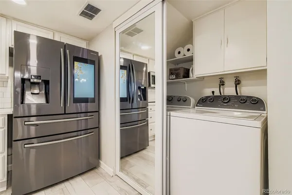 a kitchen with stainless steel appliances granite countertop a refrigerator and a stove