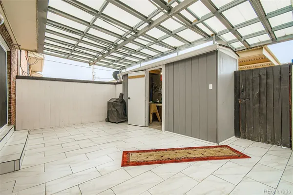 a view of a patio with couches and pool