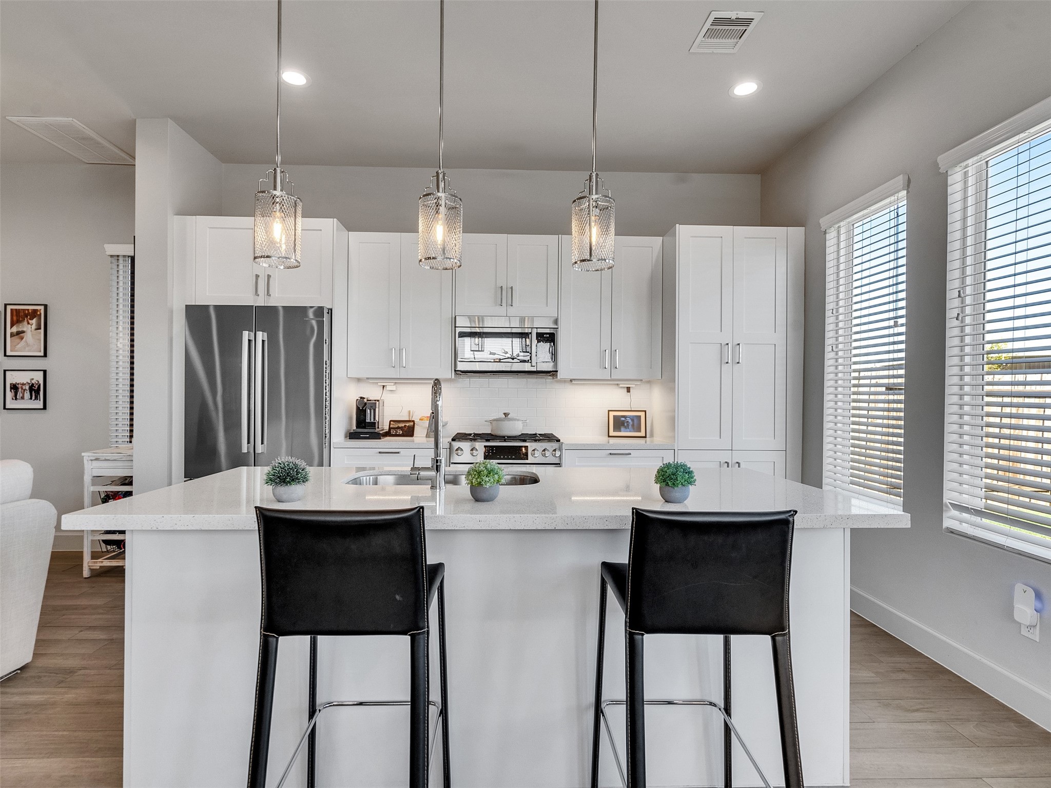 5702 Rucio Lane Houston, TX 77092 - Photo 9 of 30 a kitchen with stainless steel appliances granite countertop a sink a stove a refrigerator and island with wooden floor