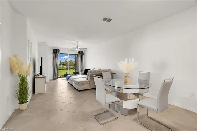 a dining room with furniture and a floor to ceiling window