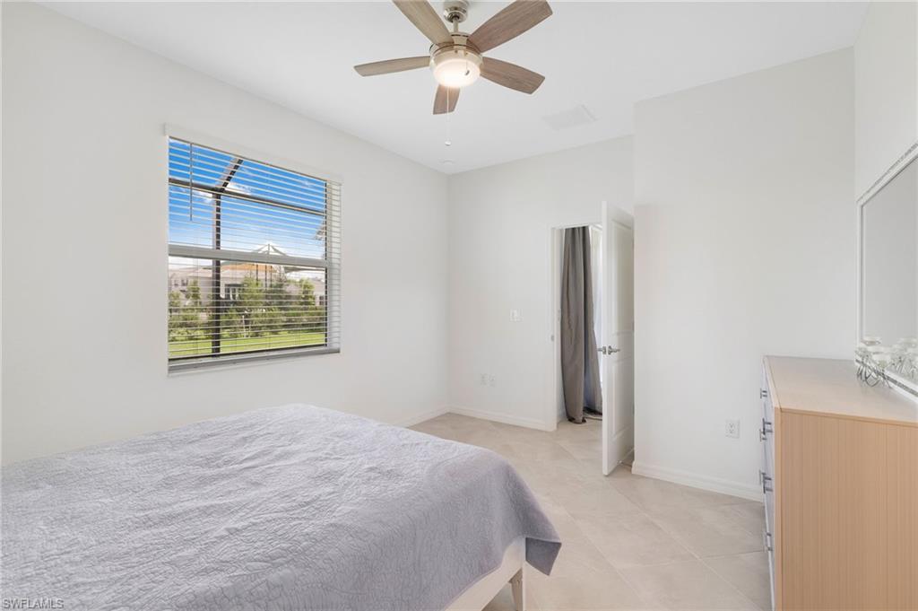 2052 Vermont Lane Naples, FL 34120 - Photo 14 of 35 a bedroom with a bed and a window