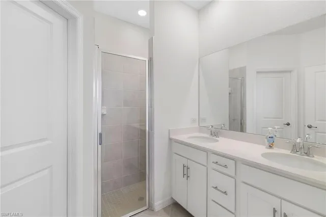a bathroom with a shower sink and mirror