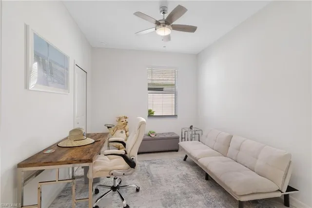 a living room with furniture a rug and a window