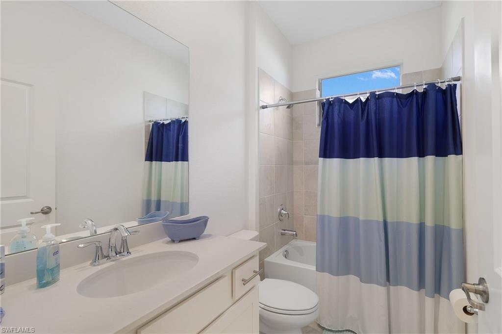 2052 Vermont Lane Naples, FL 34120 - Photo 20 of 35 a bathroom with a sink toilet and shower