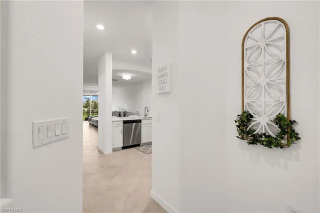 a view of entryway with kitchen and natural light