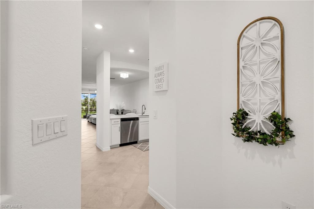 2052 Vermont Lane Naples, FL 34120 - Photo 5 of 35 a view of entryway with kitchen and natural light