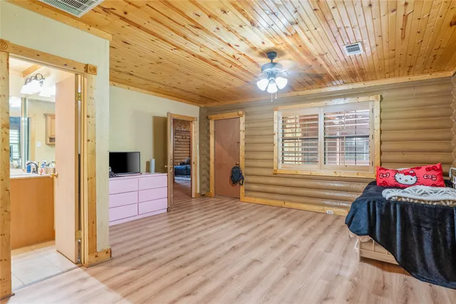 a front view of a house with a garden and trees