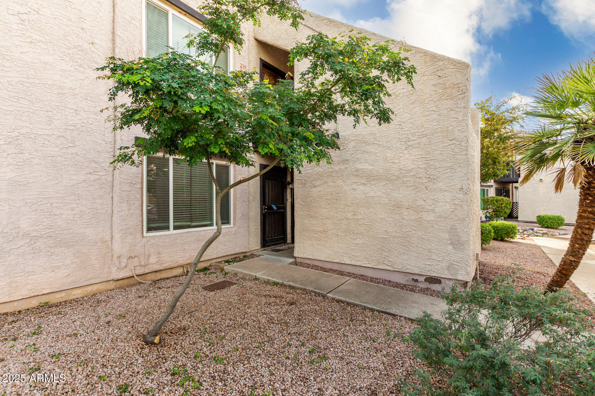 1927 East Hampton Avenue, Unit 129 Mesa, AZ 85204 - Photo 1 of 23 a plant is in front of a brick house
