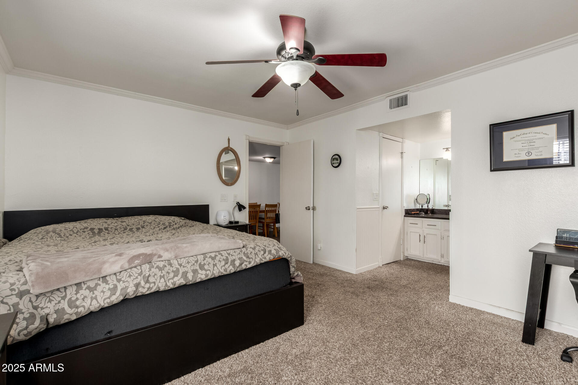 1927 East Hampton Avenue, Unit 129 Mesa, AZ 85204 - Photo 11 of 23 a spacious bedroom with a bed and a chandelier