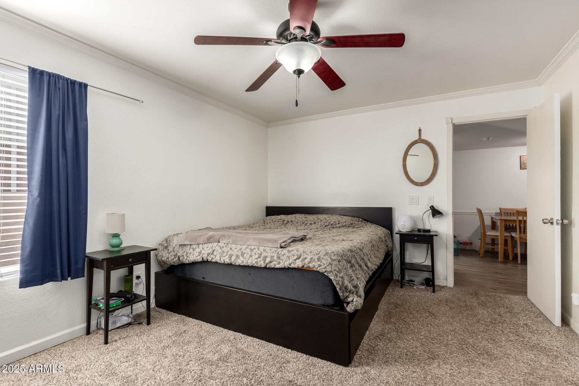 1927 East Hampton Avenue, Unit 129 Mesa, AZ 85204 - Photo 12 of 23 a bedroom with a bed and a chandelier