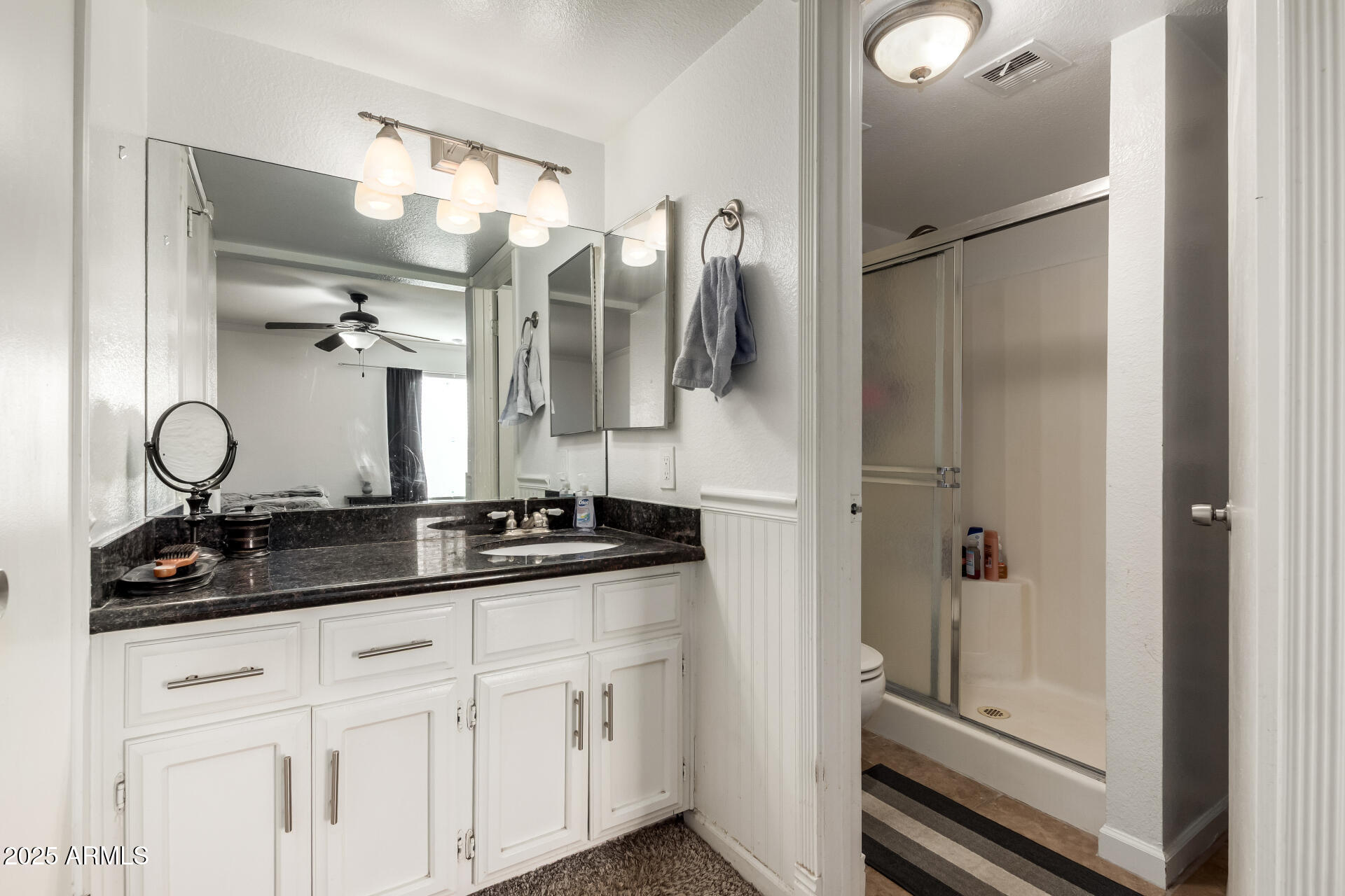 1927 East Hampton Avenue, Unit 129 Mesa, AZ 85204 - Photo 13 of 23 a bathroom with a granite countertop sink a mirror and shower