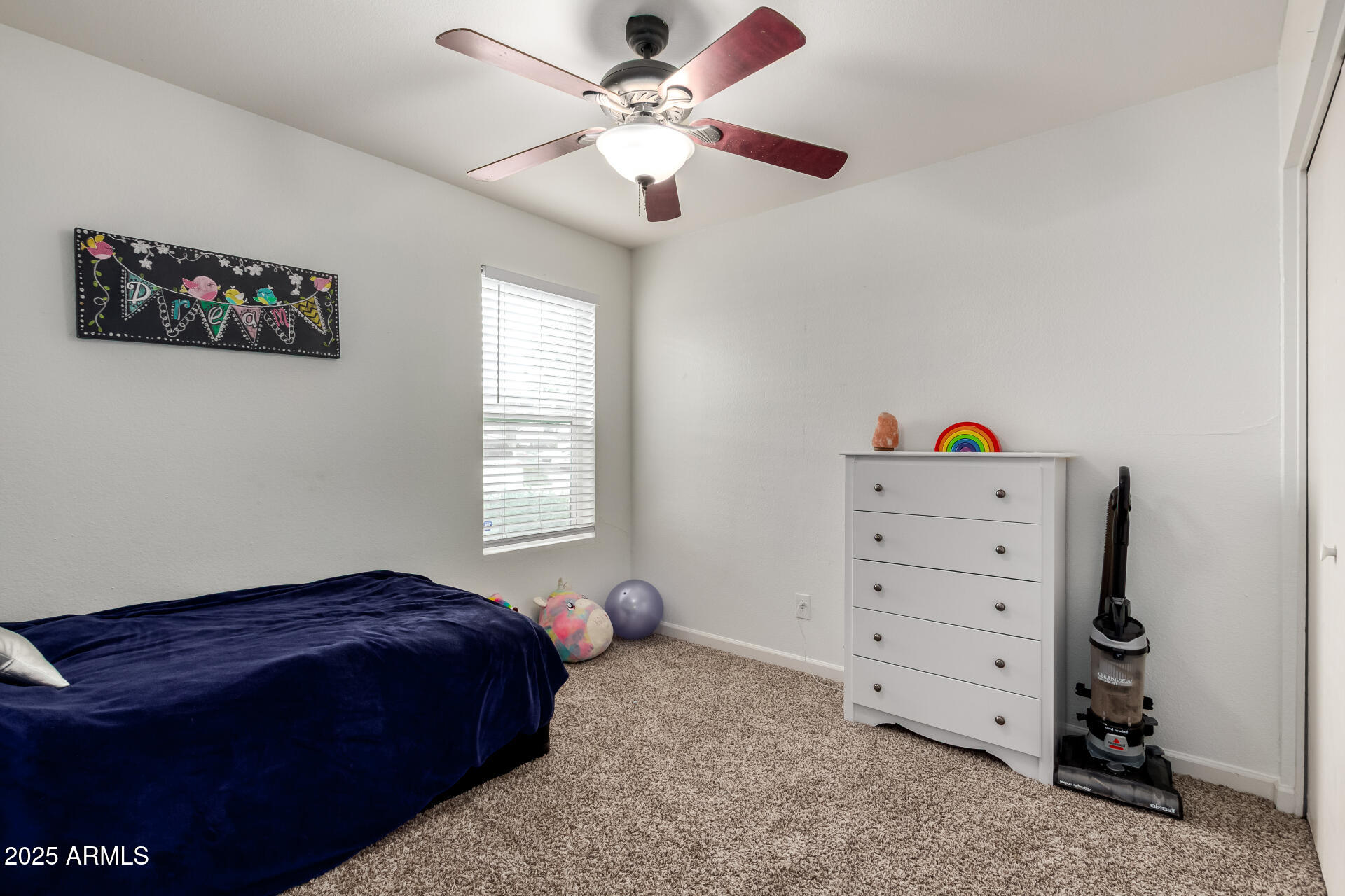 1927 East Hampton Avenue, Unit 129 Mesa, AZ 85204 - Photo 14 of 23 a bedroom with a bed and a chandelier